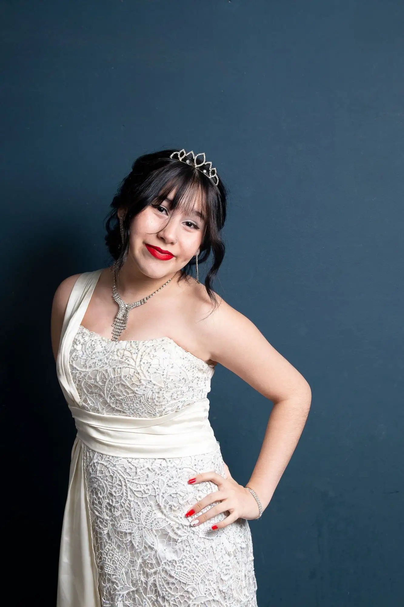Crystal tiara worn with a matching rhinestone necklace, earrings, and bracelet