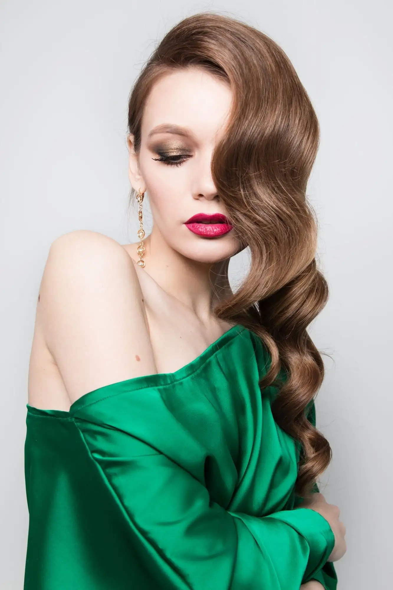 Emerald green satin off-the-shoulder bridesmaid dress with draped sleeves