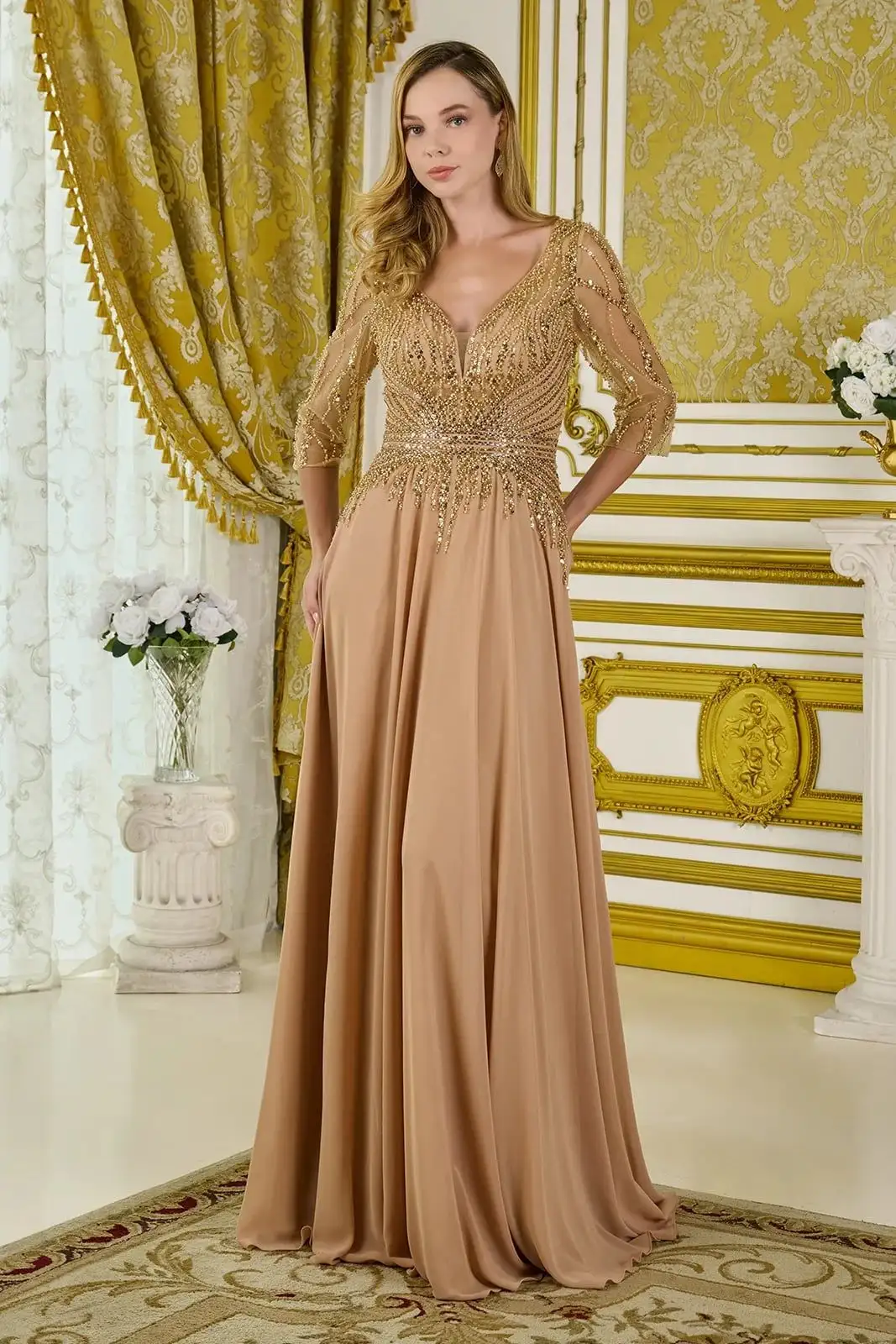 GLS Collective gold chiffon A-line gown with a beaded V-neck bodice and sheer three-quarter sleeves