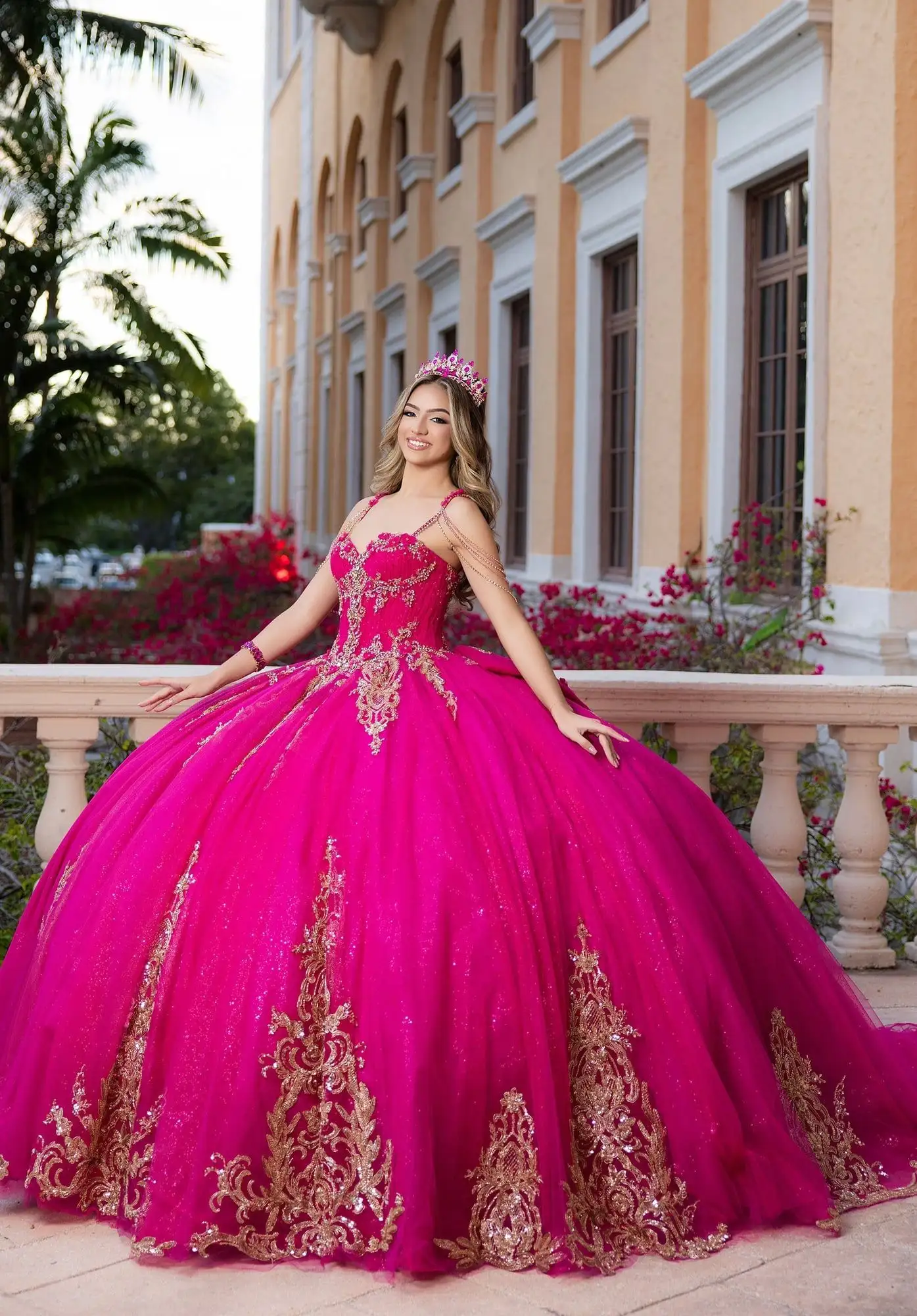 Morilee fuchsia quinceañera ball gown with gold lace appliqué and jeweled shoulder straps