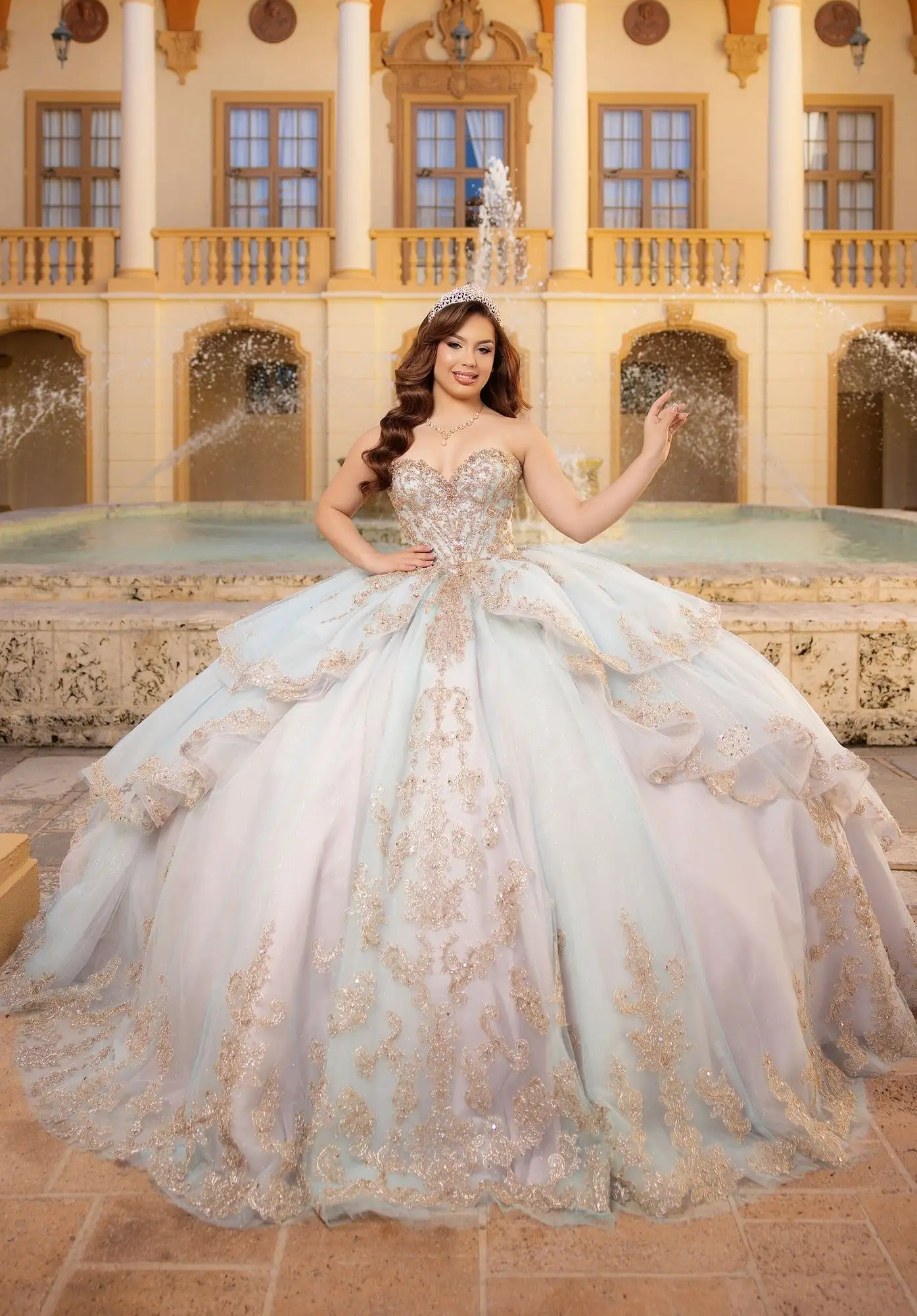 Morilee mint quinceañera ball gown with gold lace appliqué and a tiered ruffled skirt